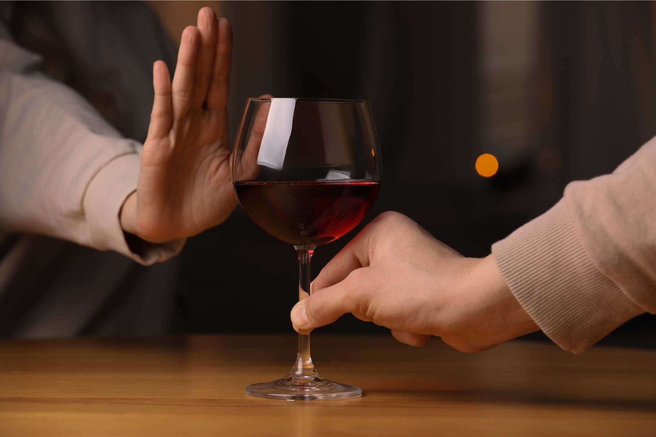 A person refusing a glass of red wine, symbolizing Key Healthcare’s commitment to alcohol addiction treatment for adolescents. This image reflects the empowerment and support provided to teens as they navigate recovery from substance abuse and develop healthier coping mechanisms.