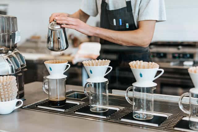 Barista precisely brewing pour-over coffee, reflecting the structured and attentive environment of Key Healthcare’s IOP
