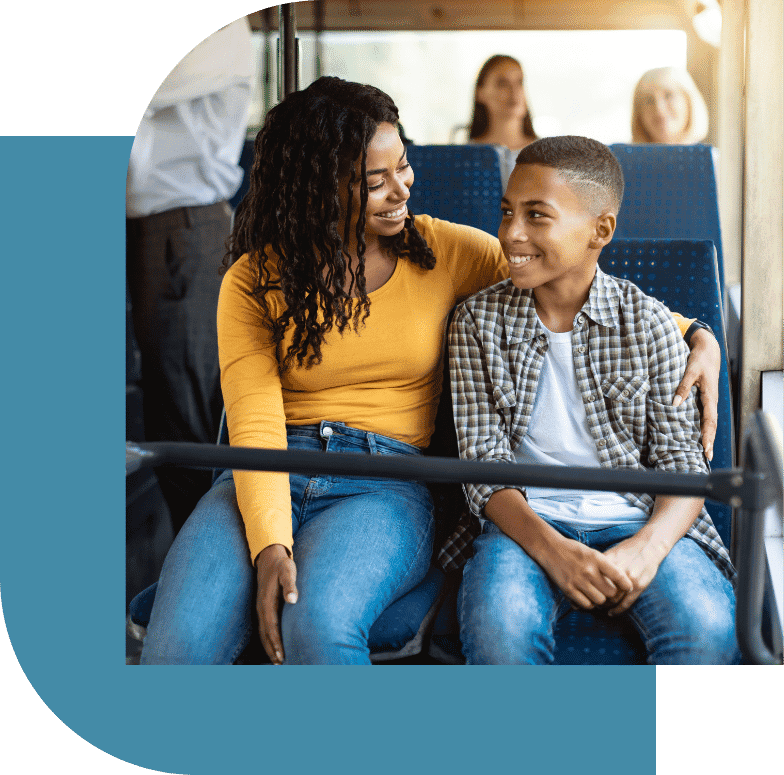 A caring adult and a teenager sharing a moment of connection on public transport, representing the support and understanding that is crucial in addressing adolescent depression